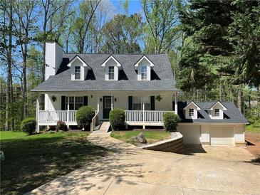 Charming Cape Cod-style home with white siding, dormer windows, and a cozy front porch at 5851 Swan Walk, Sugar Hill, GA 30518