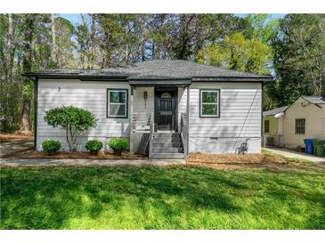 Charming single-story home with updated siding, landscaping, and a welcoming front entrance at 437 Collier Ridge Nw Dr, Atlanta, GA 30318