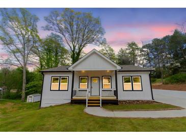 Charming single-Gathering home with a manicured lawn and inviting entrance at 5469 Helen Pl Sw, Mableton, GA 30126