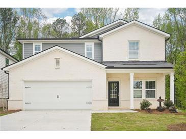 Charming two-story home with a covered front porch and attached two-car garage at 3961 Brushy St, Powder Springs, GA 30127