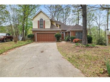 Charming home with a brick and siding exterior, a two-car garage, and a well-maintained front yard at , Stone Mountain, GA 30088