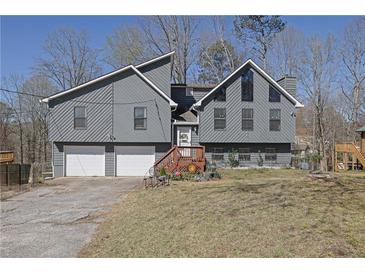 Charming two-story home with two-car garage and mature trees in a desirable neighborhood at 525 Penny Ln, Woodstock, GA 30188