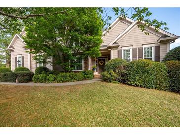 Charming single-story home with manicured lawn, mature landscaping, and inviting front entrance at 5628 Harbormist Dr, Powder Springs, GA 30127