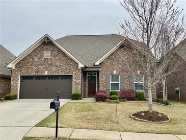 Charming brick home with well-manicured lawn and two-car garage at 725 Valley Glen Dr, Dacula, GA 30019