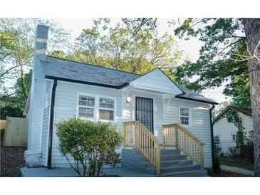 Charming house features a light blue exterior, stone chimney, and a welcoming front porch at 2022 Detroit Ave, Atlanta, GA 30314