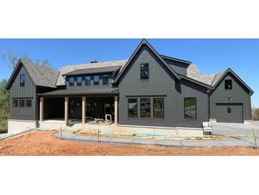 New construction exterior elevation showing board and batten siding and dark trim at 4435 Pebble Rock Dr, Cumming, GA 30041