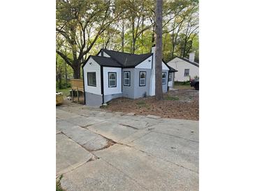 Charming remodeled home with a gray exterior, black trim, and well-kept front yard, offering curb appeal at 1427 Lorenzo Sw Dr, Atlanta, GA 30310