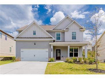 Charming two-story home with a gray exterior, manicured lawn, and attached two-car garage at 2396 Bear Mountain St, Lithonia, GA 30058