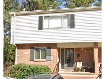 Charming townhouse featuring brick and siding facade, complemented by black shutters and a cozy front porch at 3346 Northcrest Rd # A, Atlanta, GA 30340