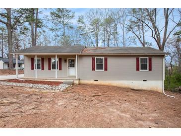 Charming ranch-style home with light siding and red shutters surrounded by trees at 5700 Tracy Dr, Mableton, GA 30126
