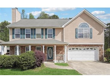 Charming two-story home featuring stone accents, a covered porch, and a well-manicured front lawn at 3380 Duncan Bridge Dr, Buford, GA 30519