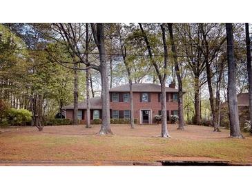 Classic brick home with mature trees offering shade and curb appeal at 746 Oak Terrace Ter, Norcross, GA 30071