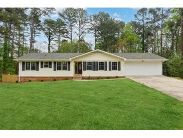 Charming single story home with a sprawling front lawn and a two car garage at 756 Butler Ct, Lawrenceville, GA 30044