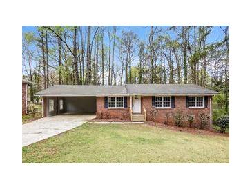 Charming single-story brick home with a welcoming front yard and a convenient carport at 3773 Sarahs Ln, Tucker, GA 30084