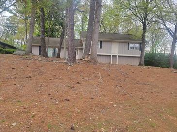 Charming single Gathering home with a quaint front facade and mature trees, creating privacy at 5251 Greenpoint Dr, Stone Mountain, GA 30088