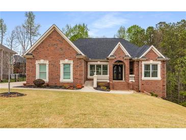 Charming brick home with well-manicured lawn and classic architectural details at 4457 Equity Ct, Ellenwood, GA 30294