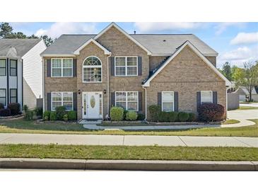 Charming two-story brick home with manicured landscaping and a welcoming front entrance at 543 Walnut Way, Palmetto, GA 30268