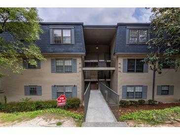 Inviting exterior of multi-level condo building with blue shutters and well-maintained landscaping at 177 Nw Amherst Pl, Atlanta, GA 30327