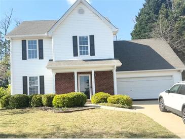 Charming two-story home boasts white siding, black shutters, and a well-manicured lawn at 3058 Arden Ridge Ter, Suwanee, GA 30024