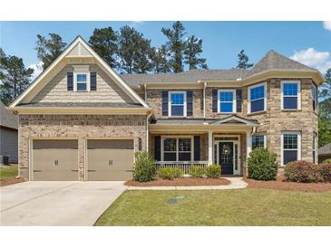 Charming brick home with a two-car garage and manicured front lawn, perfect for suburban living at 241 Haney Rd, Woodstock, GA 30188