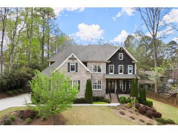 Beautiful two-story brick home with manicured lawn and mature trees at 383 Indian Hills Trl, Marietta, GA 30068