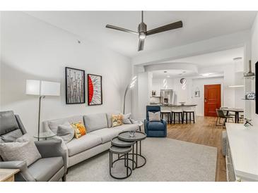 Bright living room features modern furnishings, neutral colors, ceiling fan and an open floor plan at 200 River Vista Dr # 713, Atlanta, GA 30339