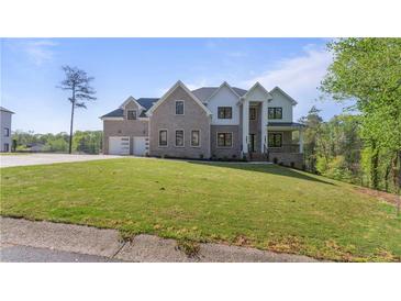 Beautiful two-story home with a large front yard and a two car garage at 208 Indian Hills Trail, Marietta, GA 30068