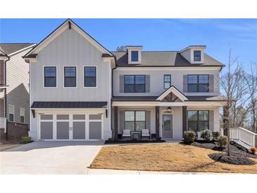 Charming two-story home showcasing a manicured lawn and a spacious two-car garage at 1501 Branthaven Ln, Auburn, GA 30011