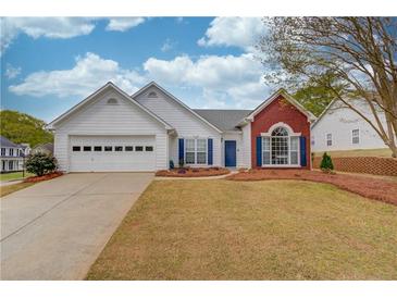 Charming one-story home featuring a two-car garage, blue shutters, and a well-maintained front yard with mature trees at 1193 Colony Creek Ct, Lawrenceville, GA 30043