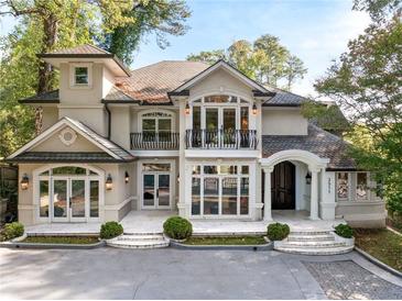 Stunning two-story home with a grand entrance, balcony, and manicured landscaping at 3511 Roxboro Ne Rd, Atlanta, GA 30326