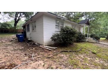 View of a white single story home with a covered front porch and landscape at 6194 Polly Anna Se Ave, Covington, GA 30014
