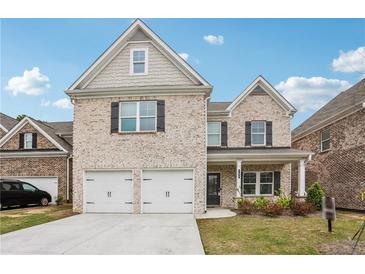 Beautiful two-story brick home with a two-car garage and well-manicured lawn at 795 Clark Lake Estates Dr, Grayson, GA 30017