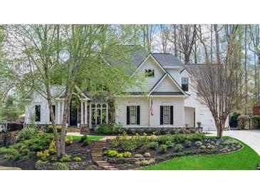 Charming two-story home with manicured front yard, stone steps, and flowering trees at 2305 Whiting Bay Cts, Kennesaw, GA 30152