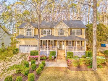Charming two-story home with a welcoming front porch and beautifully landscaped front yard at 825 Clarion Way, Lawrenceville, GA 30044