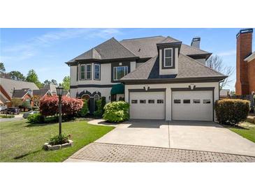 Elegant two-story home boasting a well-manicured lawn, two-car garage and manicured landscaping at 341 Declaire Ne Way, Marietta, GA 30067