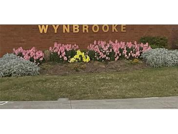 Wynbrooke community sign with colorful flower beds in front of it at 787 Wynbrooke Pkwy, Stone Mountain, GA 30087