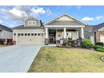 Charming home with a well-maintained front lawn and a welcoming front porch with classic columns at 230 Hickory Chase, Canton, GA 30115