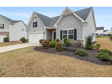 Charming home with manicured lawn, mature landscaping and attached garage at 4470 Madison Hall Dr, Cumming, GA 30028