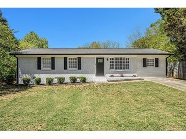 Charming single-story home boasts a well-manicured lawn and fresh exterior paint at 2804 Carolyn Se Dr, Smyrna, GA 30080