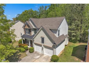 Aerial view of a two-story home with a two-car garage and a well-manicured lawn at 818 Prada Ct, Lawrenceville, GA 30043
