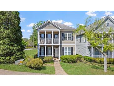 Charming two-story home with a welcoming front porch and well-manicured landscaping at 121 Dunleith Sw Pkwy, Marietta, GA 30008