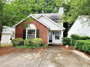 Charming brick-and-vinyl home with lush landscaping and a cozy front porch at 645 Crossbridge Aly, Johns Creek, GA 30022