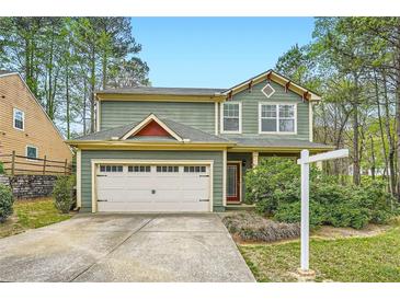 Charming two-story home boasts an attached two-car garage and a well-maintained lawn with surrounding greenery at 3765 Clear Lake Nw Way, Acworth, GA 30101