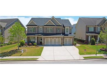 Beautiful two-story home with brick and siding exterior, three-car garage, and well-manicured front yard at 715 Laura Jean Court, Buford, GA 30518