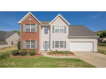 Charming two-story home featuring a well-maintained lawn and a two-car garage at 2470 Cordillo Dr, Dacula, GA 30019