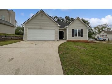 Charming single-Gathering home features a two-car garage, well-maintained lawn and driveway at 100 Chartres St, Dallas, GA 30157