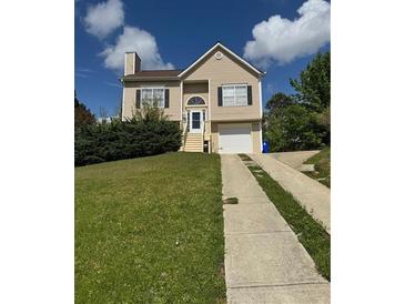 Charming two-story home featuring a well-manicured lawn and a classic suburban aesthetic at 4423 Roche St, Atlanta, GA 30349
