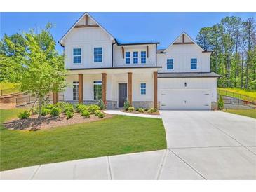 Beautiful two-story home with white siding, manicured lawn, and inviting front porch at 399 Tillman Pass, Woodstock, GA 30188