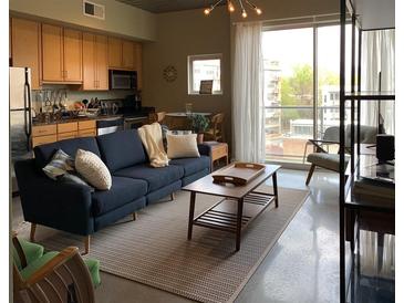Bright, open living space featuring a comfortable couch, modern decor, and large windows with city views at 620 Glen Iris Ne Dr # 401, Atlanta, GA 30308