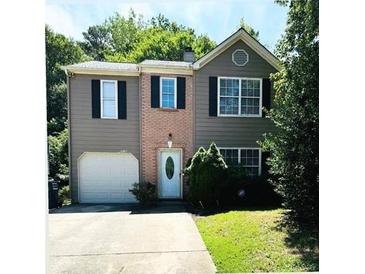 Charming two-story home with a well-maintained lawn and an attached one car garage at 6715 Roscommon Dr, Austell, GA 30168